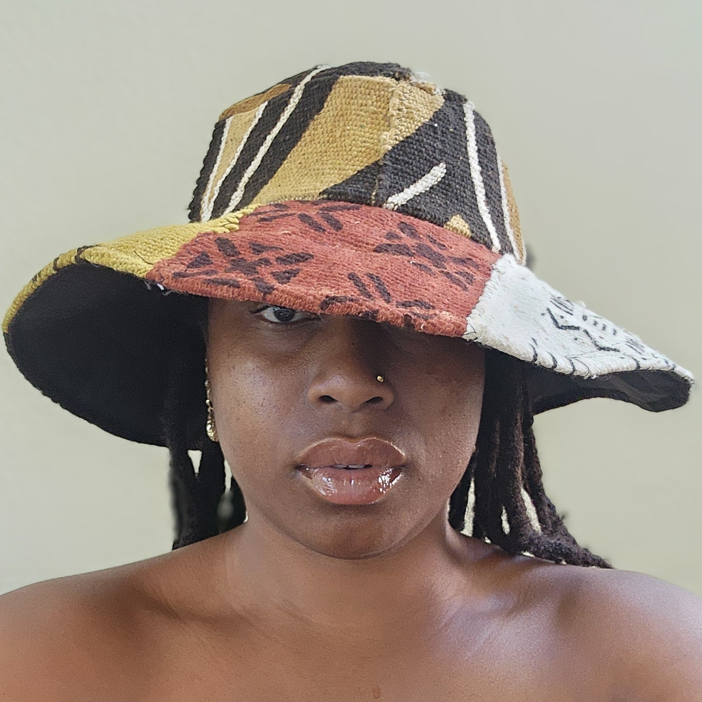 Brown, black, mustard yellow, rust red and white mudcloth bucket hat